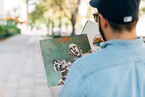 young Man with queen disk in hand