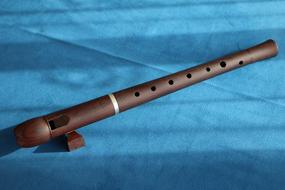 wooden Flute on blue tissue