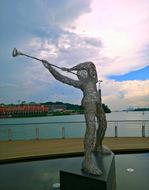 man plays trumpet, Wire Sculpture on embankment