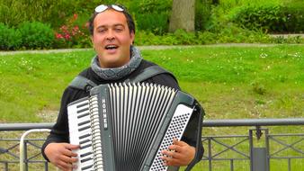 adult man Playing Accordion in park