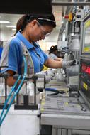 girl in a protective suit at an industrial plant