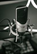 black and white photo of a microphone in the studio