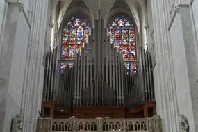 Organ in front of stained glass window in Church