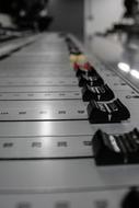 Music Mixing Console close-up in blurred background