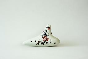 white ceramic musical instrument with flower patterns