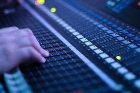 male hand on sound Console