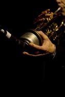 hand on jazz trumpet in the dark