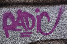 Radio, purple Graffiti on grey Wall