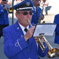 Uniformed senior man plays Trumpet