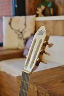 Close-up of the beautiful, wooden guitar, with the sign