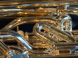 Shiny gold brass instrument with pipes