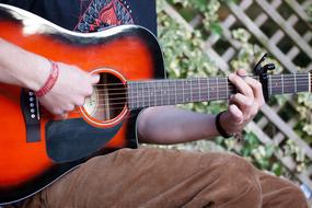 red and black Guitar in female hands