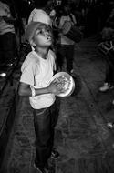 Child boy plays drum on Festival, Nepal