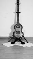 Black and white photo of the guitar and high-heeled shoes