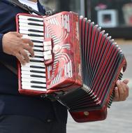 man plays accordion outdoor