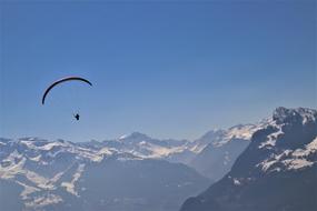 parachute soaring in mountains