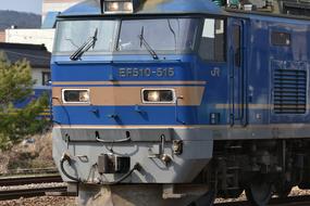 Beautiful, old, blue and brown train, among the plants on landscape