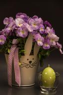 Easter egg shaped candle and purple potted flower