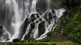 Beautiful waterfall with rocks and green plants in Azores, Portugal