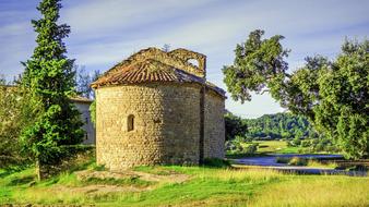 old stone chapel at summer rural landscape