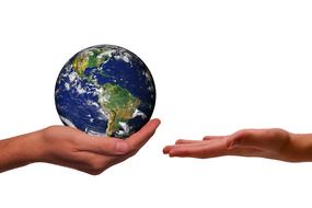 Hand with Earth globe and empty open hand at white background