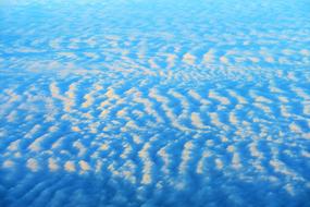 waves of clouds in the blue sky