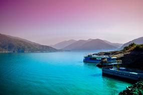 romantic photo of the landscape of blue river Ganges against the pink sky in India