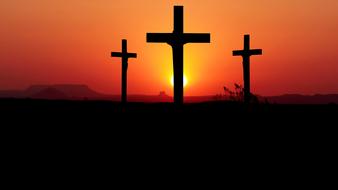 three crosses at sunset sky