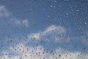 raindrops on glass against a background of clouds