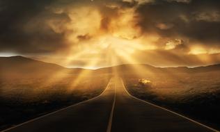 sunbeams over empty asphalt Road to Horizon