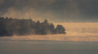 fog over a cold lake at dusk