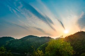sun rays over mountains in guiyang