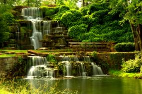 Beautiful waterfall on the rocks, among the green plants