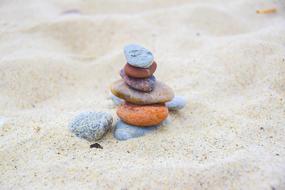 multi-colored piled pebbles in the sand