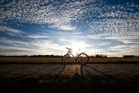 parked bicycle at scenic evening sky