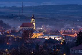 illuminated Church in small town at dusk