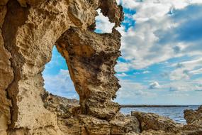 natural arch on a rock by the sea
