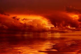 Beautiful waterscape at red and orange, gradient sunset with clouds