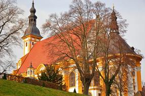 Beautiful and colorful monastery with steeples, among the trees in Neuzelle, Germany