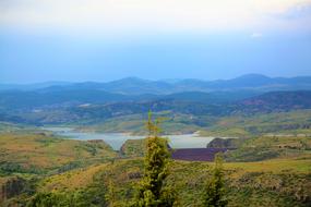 distant view of the dam amidst a picturesque landscape