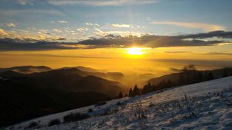 scenic sunrise in mountains at snowy winter