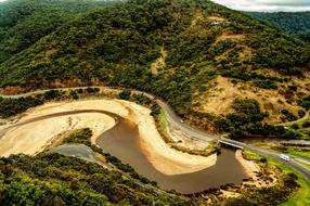 panorama of road, green hills and river
