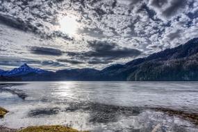 Sun over lake weissensee lake, austria