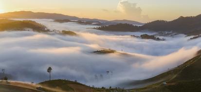 panoramic view of mountains in dense fog