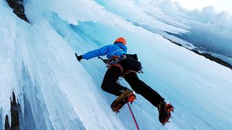 Person, climbing on the beautiful, white and turquoise ice