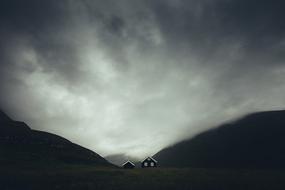 scenic Landscape, village houses in mountain valley at dusk, Denmark, faroe islands