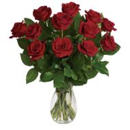 bouquet of red roses in a glass vase on a white background