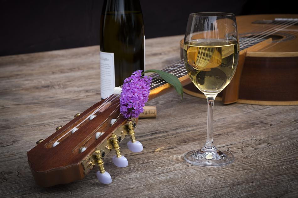 Wine and guitar on table