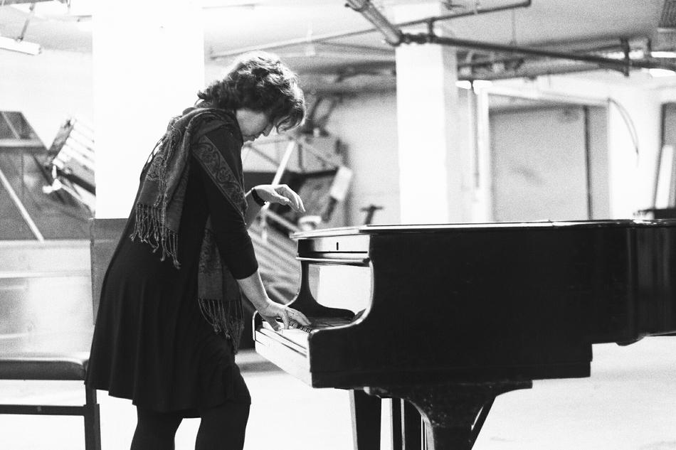 woman and piano in black and white background