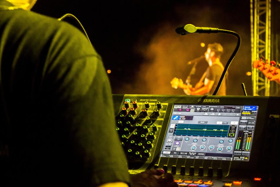 the musician is behind the mixer at the concert